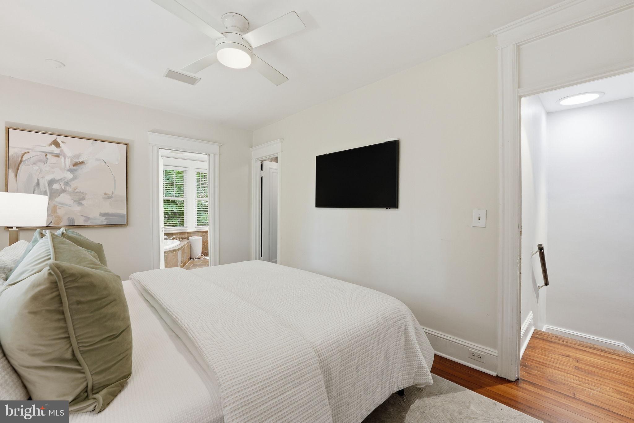 3512 30th Street Northwest Washington, DC 20008 - Photo 16 of 41 a bedroom with a bed and a flat screen tv
