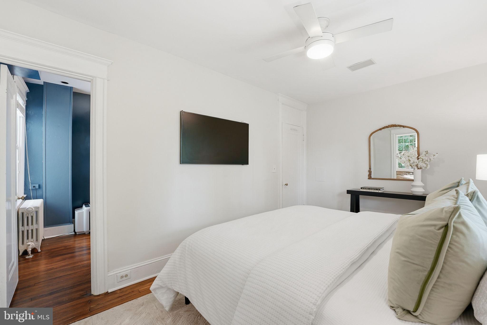 3512 30th Street Northwest Washington, DC 20008 - Photo 17 of 41 a bedroom with a bed and a flat screen tv