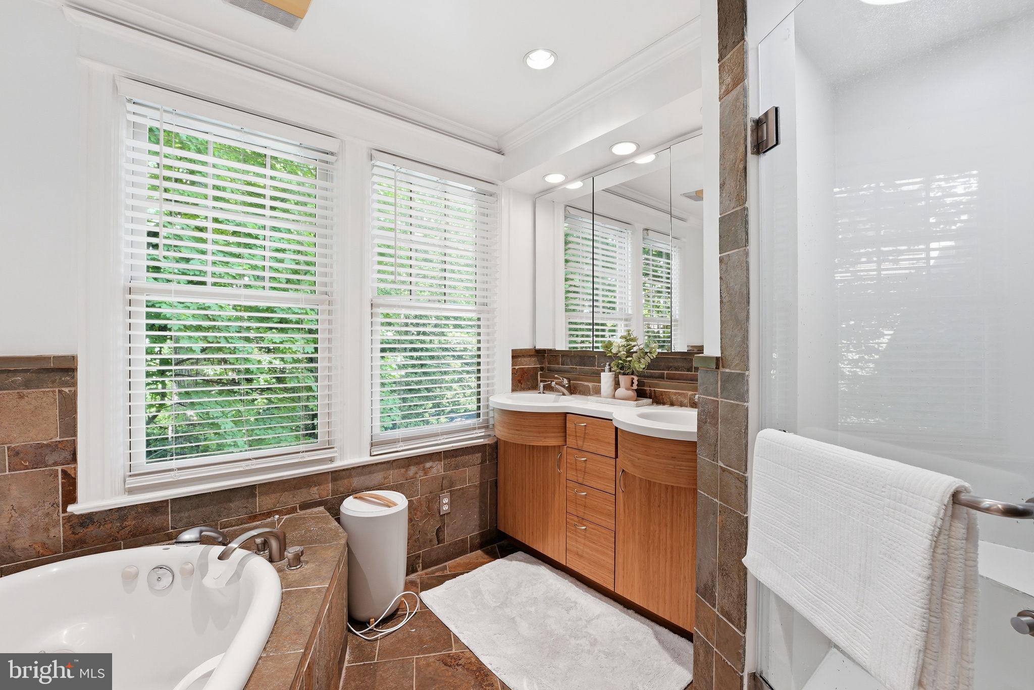 3512 30th Street Northwest Washington, DC 20008 - Photo 20 of 41 a bathroom with a large tub sink and mirror
