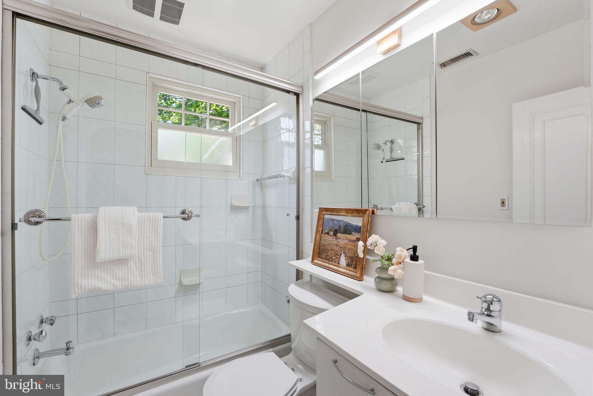 3512 30th Street Northwest Washington, DC 20008 - Photo 24 of 41 a bathroom with a shower sink and mirror
