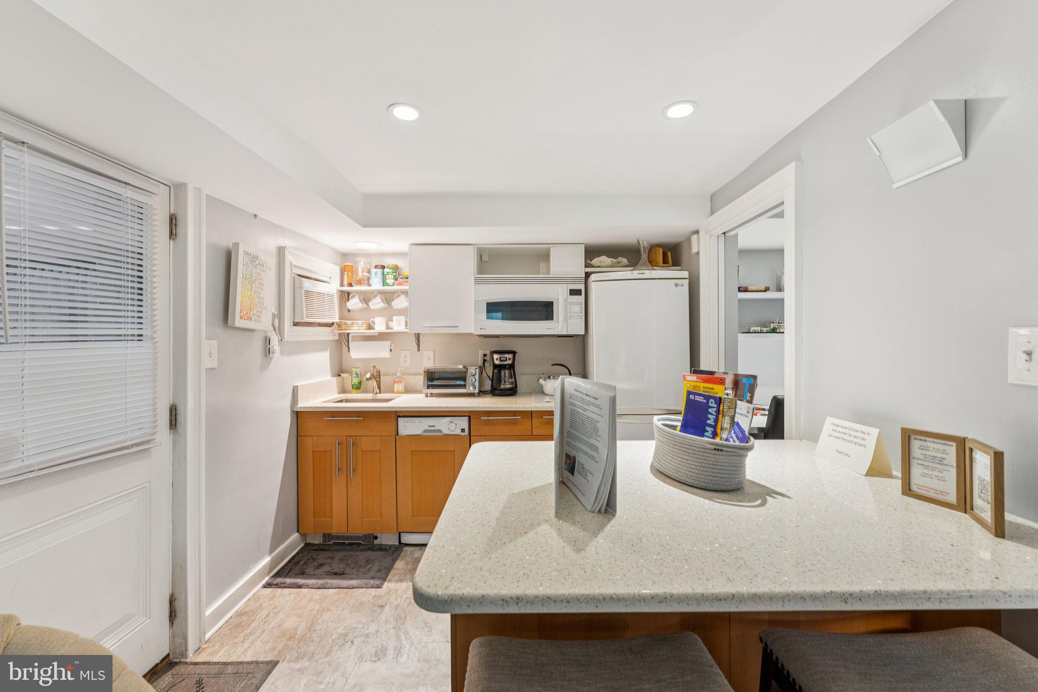 3512 30th Street Northwest Washington, DC 20008 - Photo 35 of 41 a large white kitchen with stainless steel appliances
