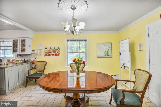 a dining room with furniture a livingroom and chandelier