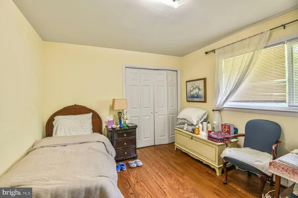 a bedroom with a bed and a chair