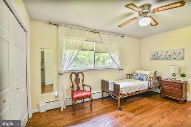 a bedroom with a bed and a window