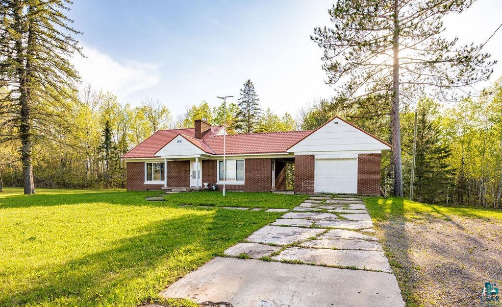 4543 County Road East South Range, WI 54874 - Photo 5 of 43 Brick exterior home featuring a red roof, an attached one-car garage, and a covered front entry