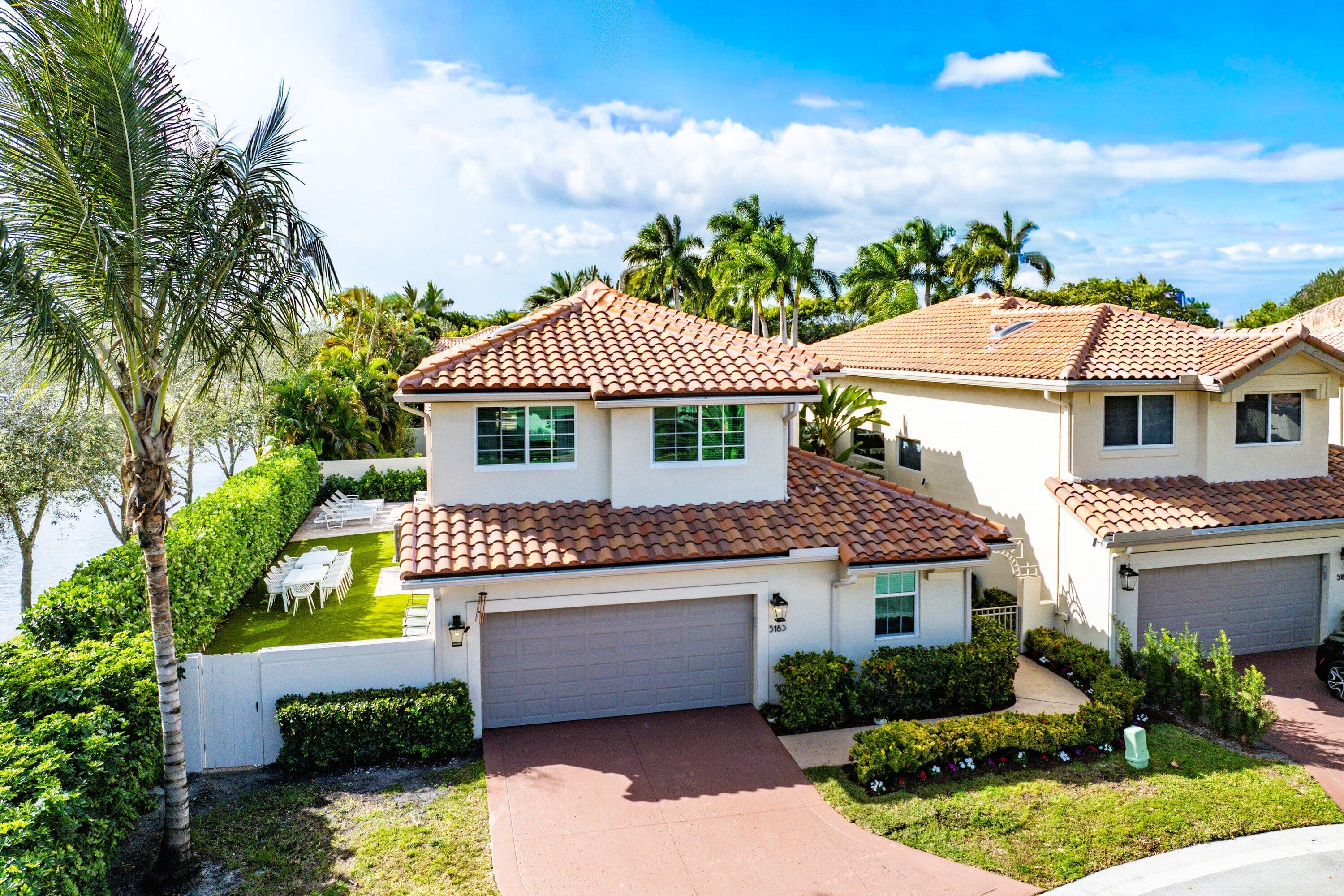 5183 Northwest 25th Way Boca Raton, FL 33496 - Photo 1 of 73 front view of a house with a yard