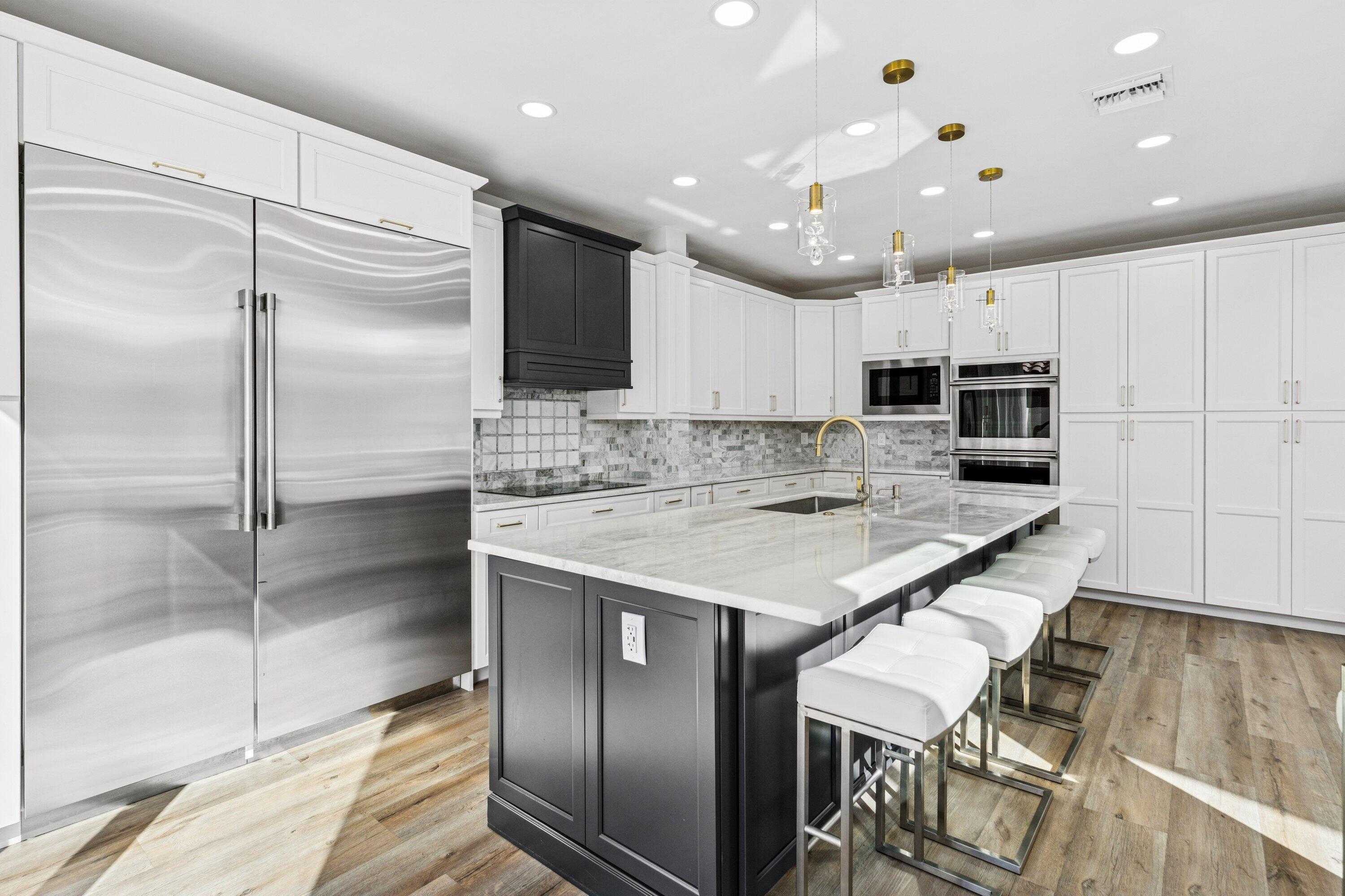 5183 Northwest 25th Way Boca Raton, FL 33496 - Photo 11 of 73 a kitchen with kitchen island granite countertop stainless steel appliances cabinets a sink and a counter top space