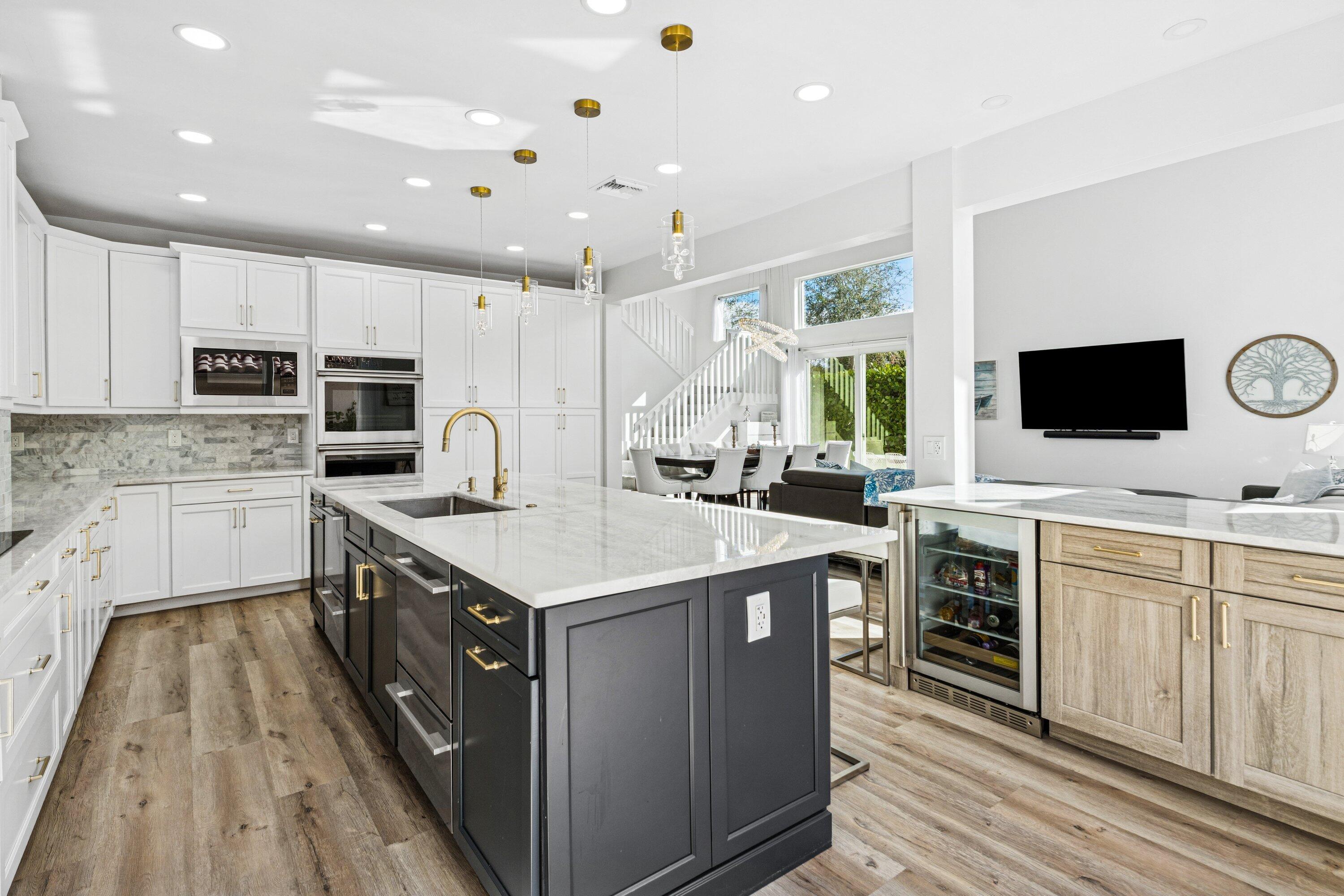 5183 Northwest 25th Way Boca Raton, FL 33496 - Photo 12 of 73 a kitchen with kitchen island granite countertop a sink appliances cabinets and furniture