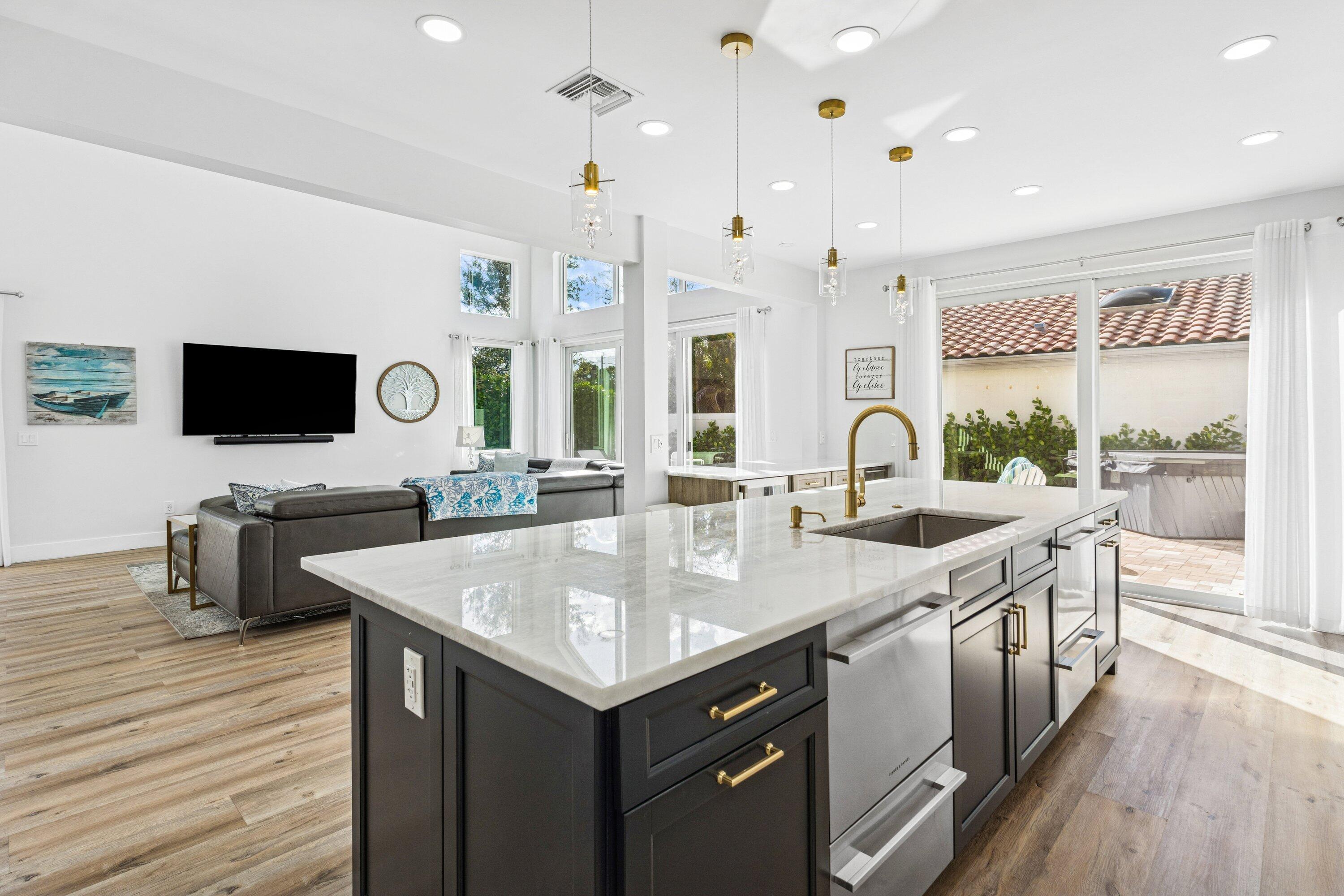 5183 Northwest 25th Way Boca Raton, FL 33496 - Photo 13 of 73 a kitchen with stainless steel appliances granite countertop a sink and a stove