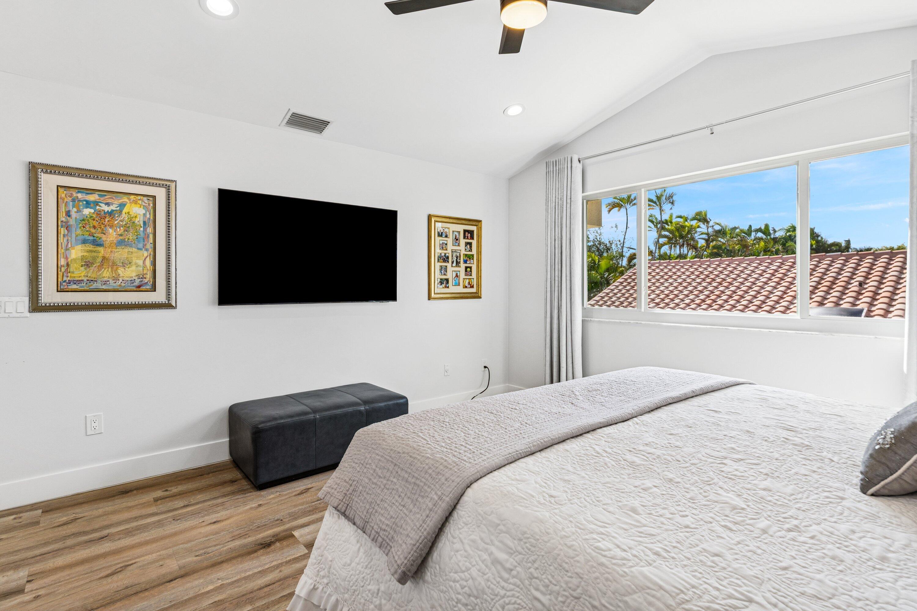 5183 Northwest 25th Way Boca Raton, FL 33496 - Photo 16 of 73 a bedroom with a bed and a flat screen tv