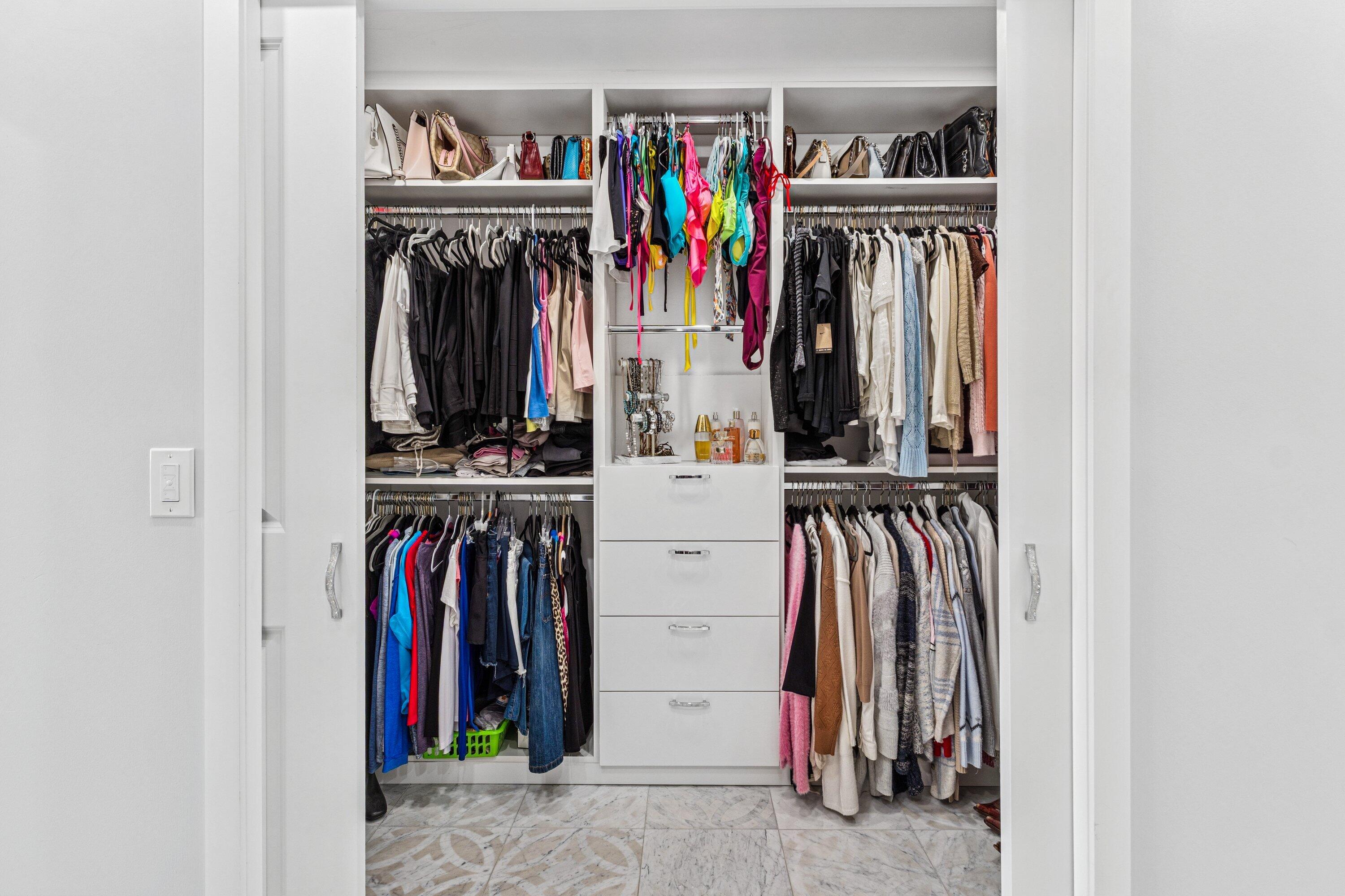 5183 Northwest 25th Way Boca Raton, FL 33496 - Photo 19 of 73 a view of walk in closet with clothes and shoes