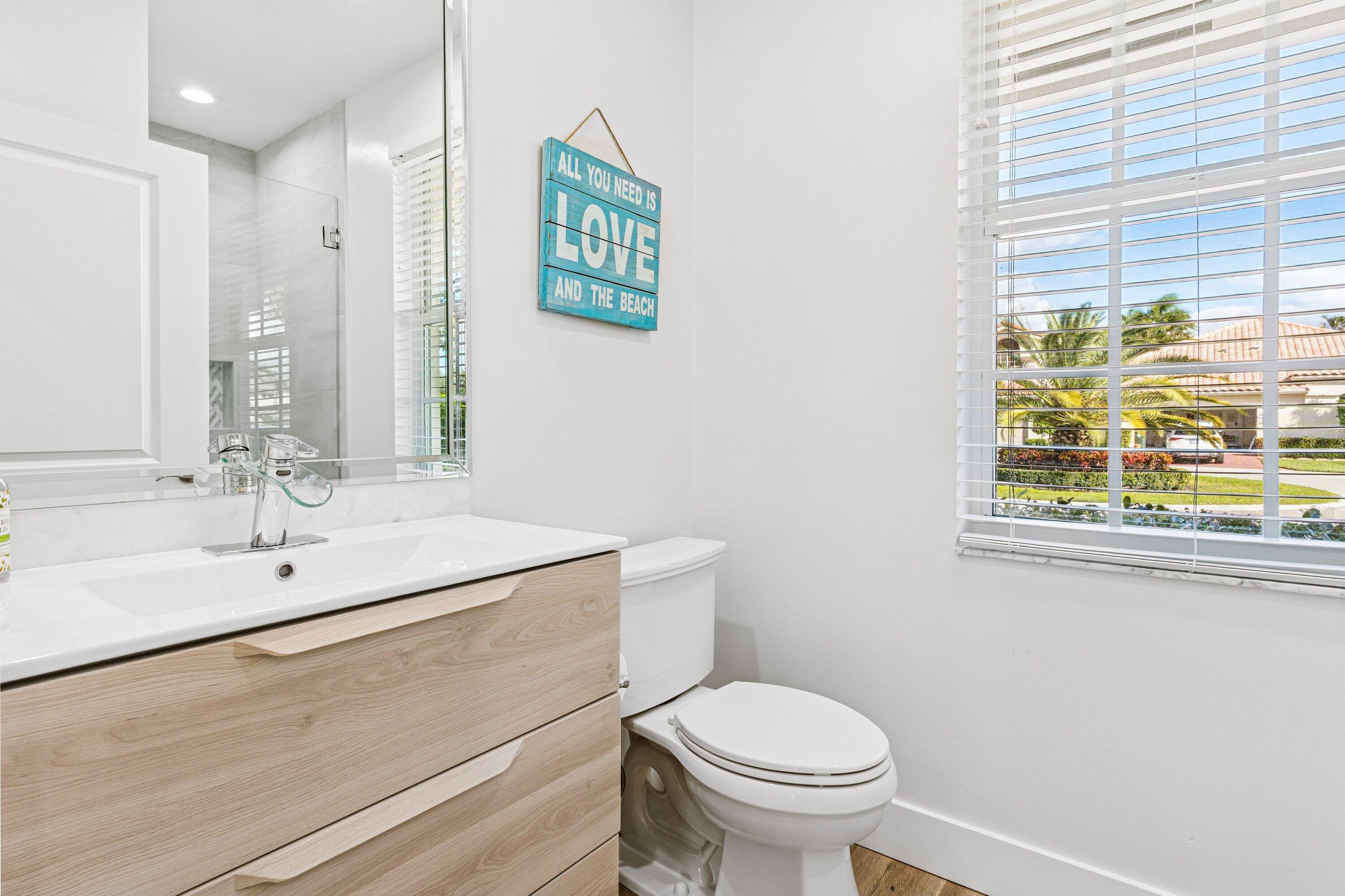 5183 Northwest 25th Way Boca Raton, FL 33496 - Photo 26 of 73 a bathroom with a sink a toilet and a window