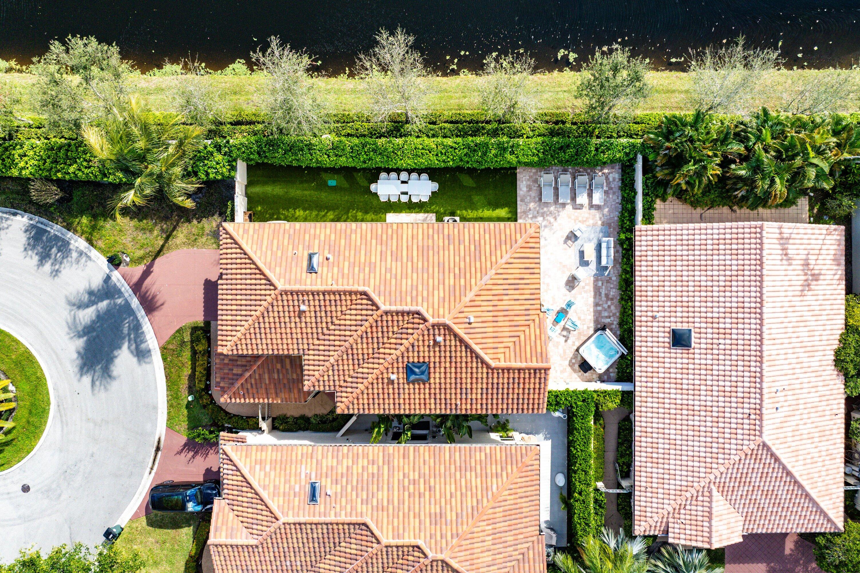 5183 Northwest 25th Way Boca Raton, FL 33496 - Photo 32 of 73 an aerial view of a house with a yard and swimming pool