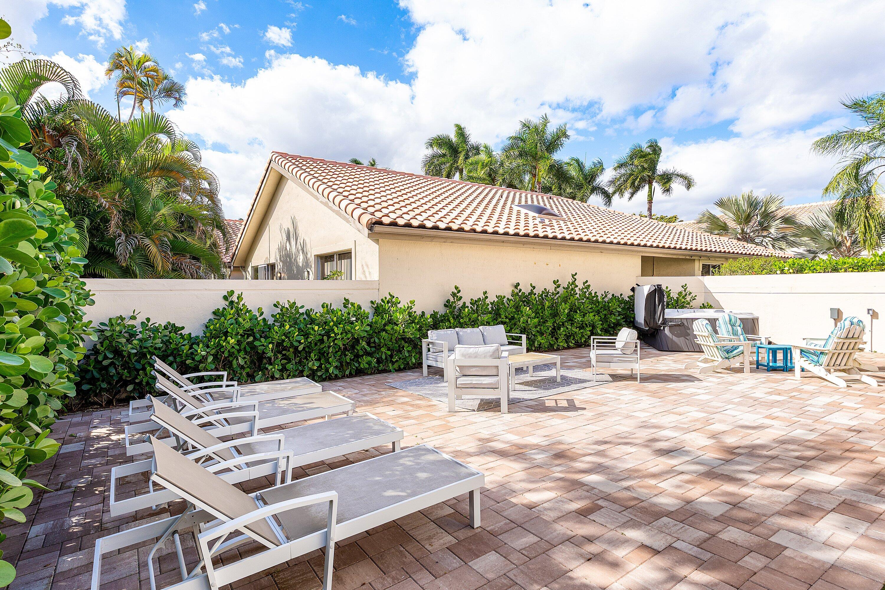 5183 Northwest 25th Way Boca Raton, FL 33496 - Photo 39 of 73 a view of a patio with a table and chairs under an umbrella