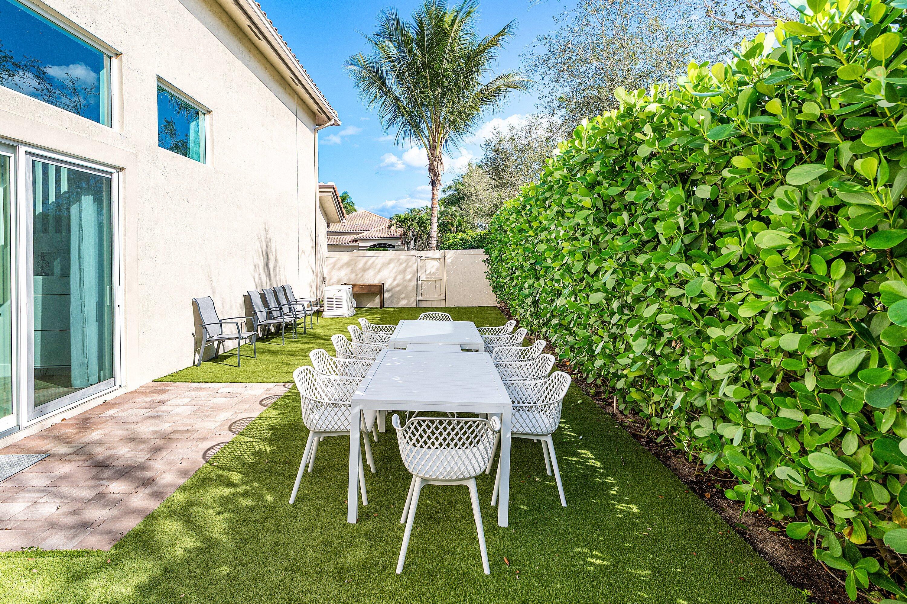 5183 Northwest 25th Way Boca Raton, FL 33496 - Photo 40 of 73 a view of a chairs and table in backyard