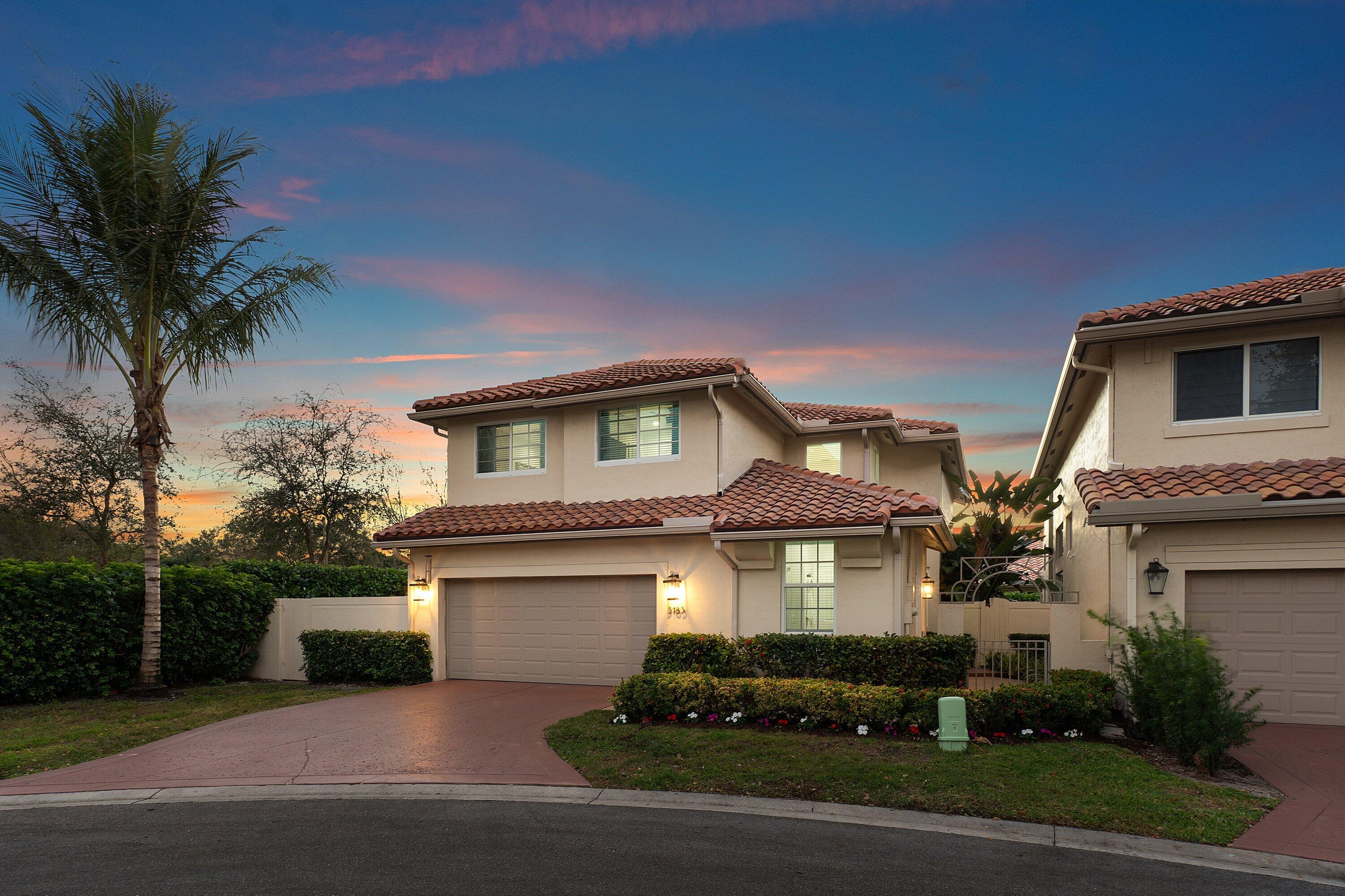 5183 Northwest 25th Way Boca Raton, FL 33496 - Photo 43 of 73 a front view of a house with a yard and garage