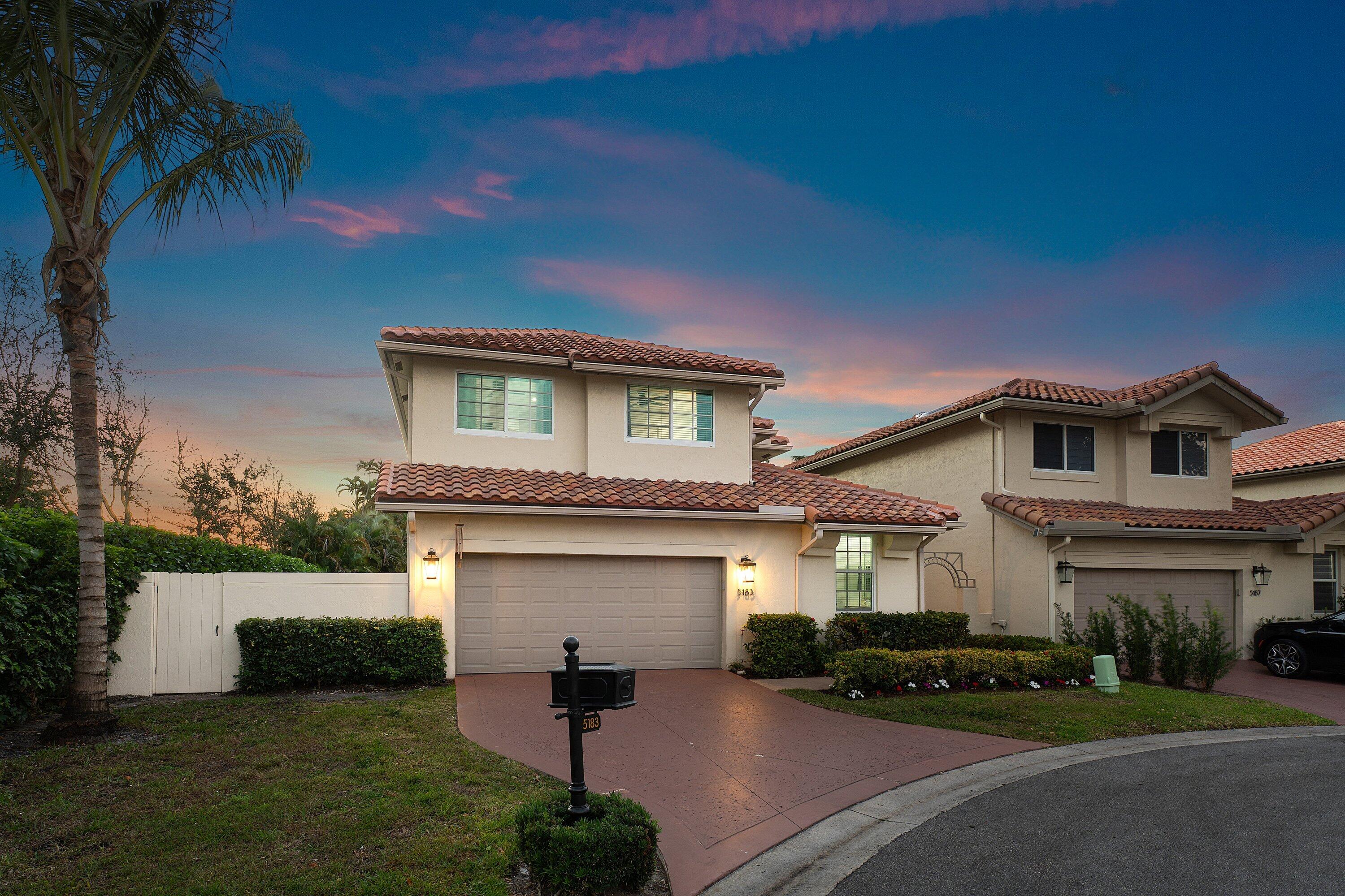 5183 Northwest 25th Way Boca Raton, FL 33496 - Photo 44 of 73 a front view of a house with a yard