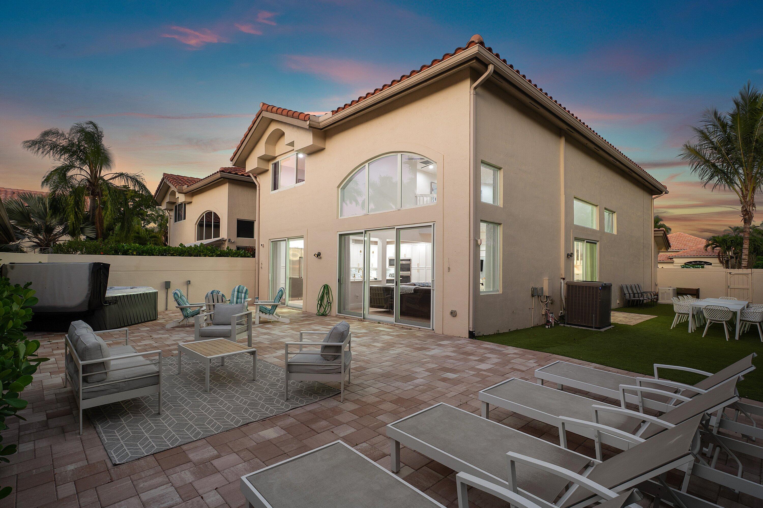 5183 Northwest 25th Way Boca Raton, FL 33496 - Photo 46 of 73 a view of a patio with couches table and chairs and potted plants