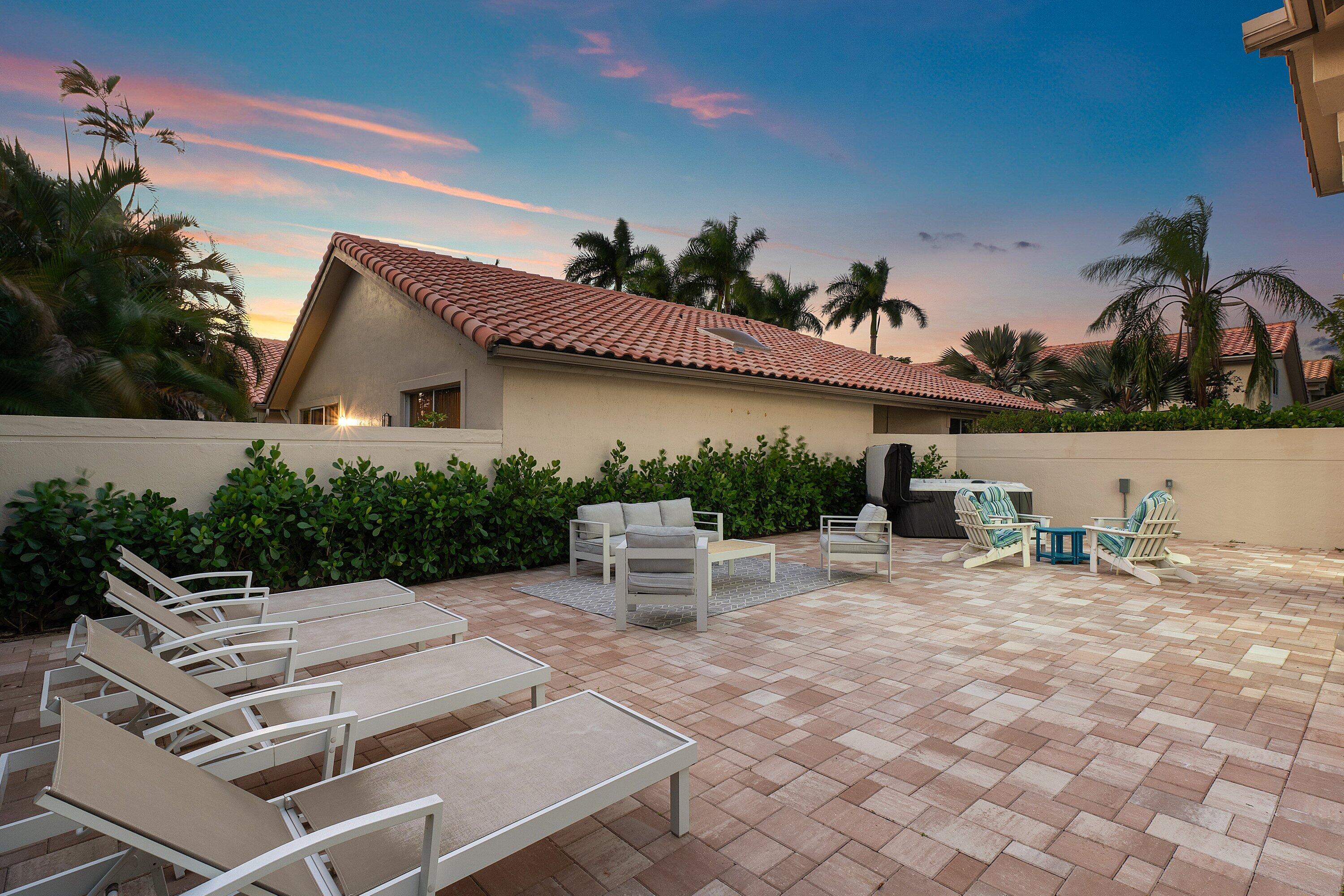 5183 Northwest 25th Way Boca Raton, FL 33496 - Photo 48 of 73 a view of a patio with a table and chairs under an umbrella
