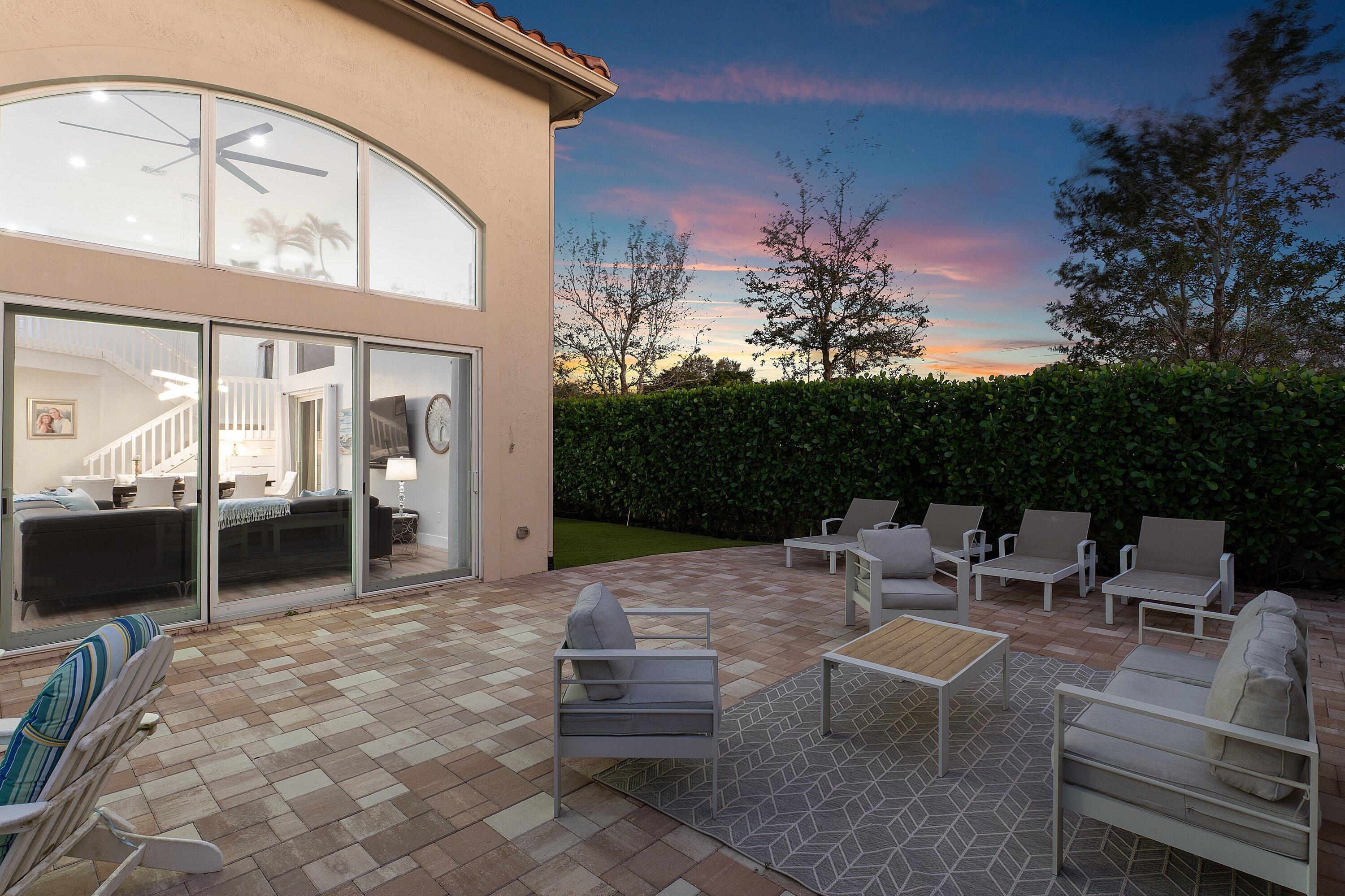 5183 Northwest 25th Way Boca Raton, FL 33496 - Photo 50 of 73 a view of a patio with a dining table and chairs with wooden floor