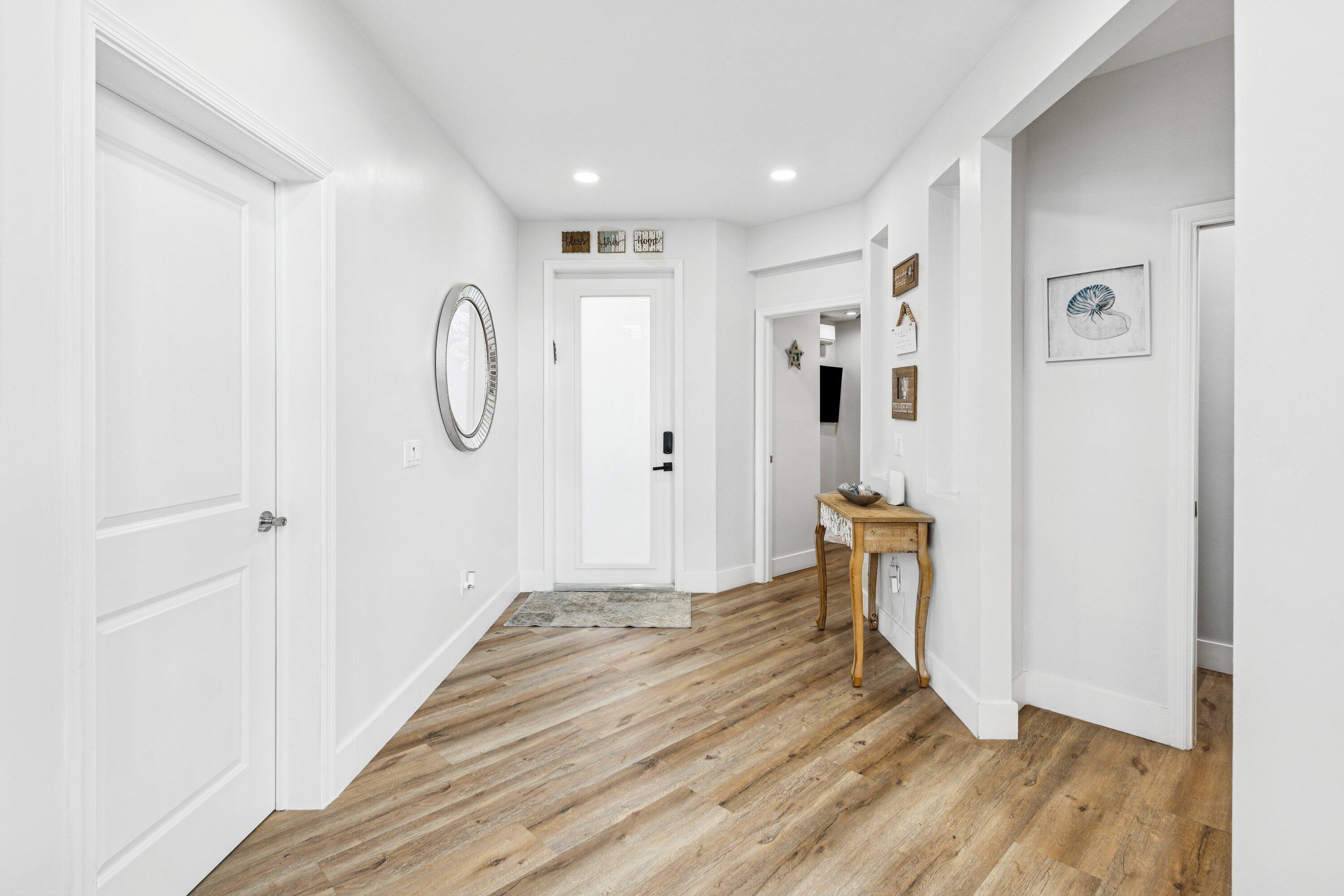 5183 Northwest 25th Way Boca Raton, FL 33496 - Photo 5 of 73 a view of a hallway with wooden floor and entryway
