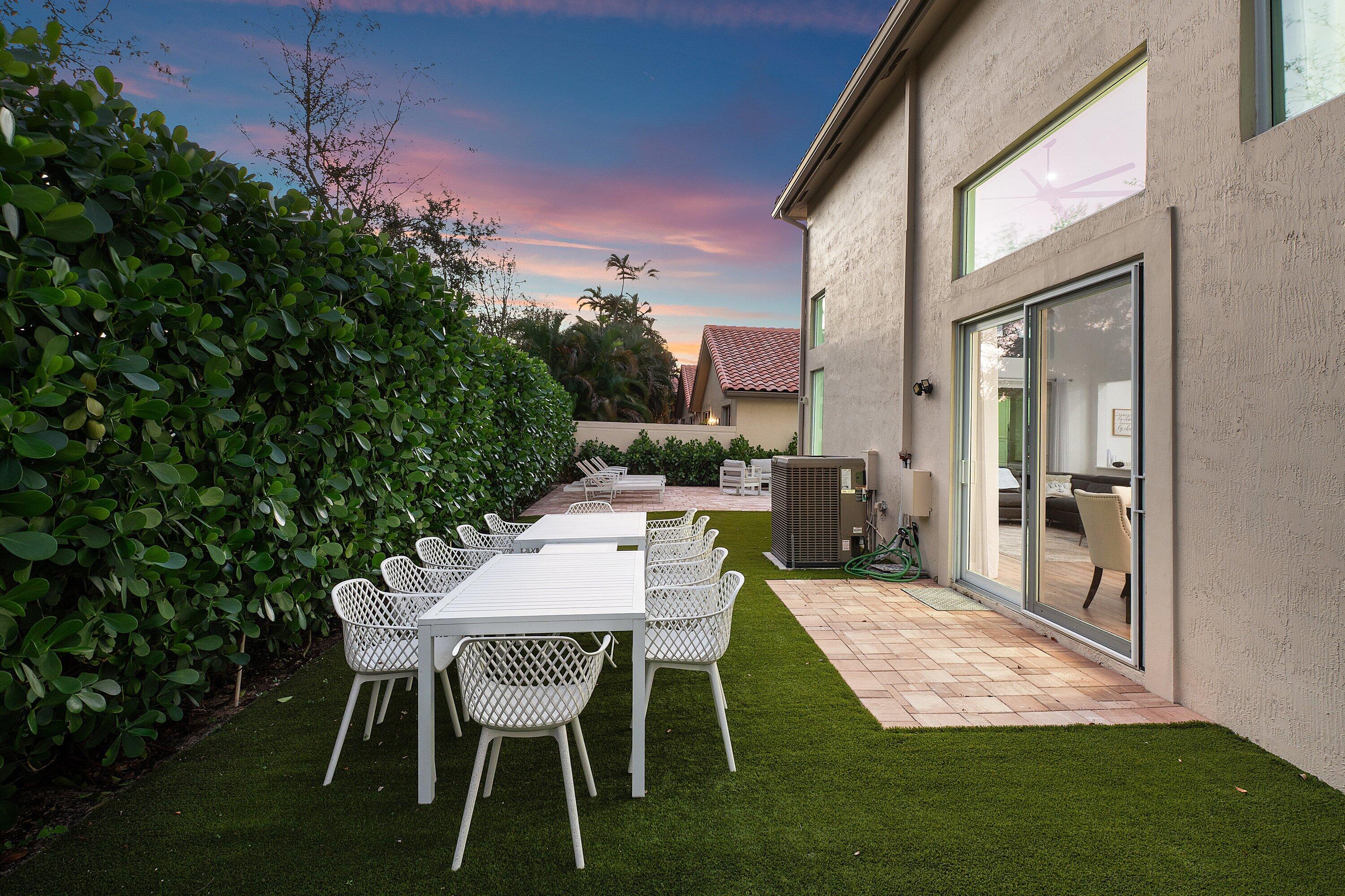 5183 Northwest 25th Way Boca Raton, FL 33496 - Photo 51 of 73 a view of an outdoor dining space with a table and chairs