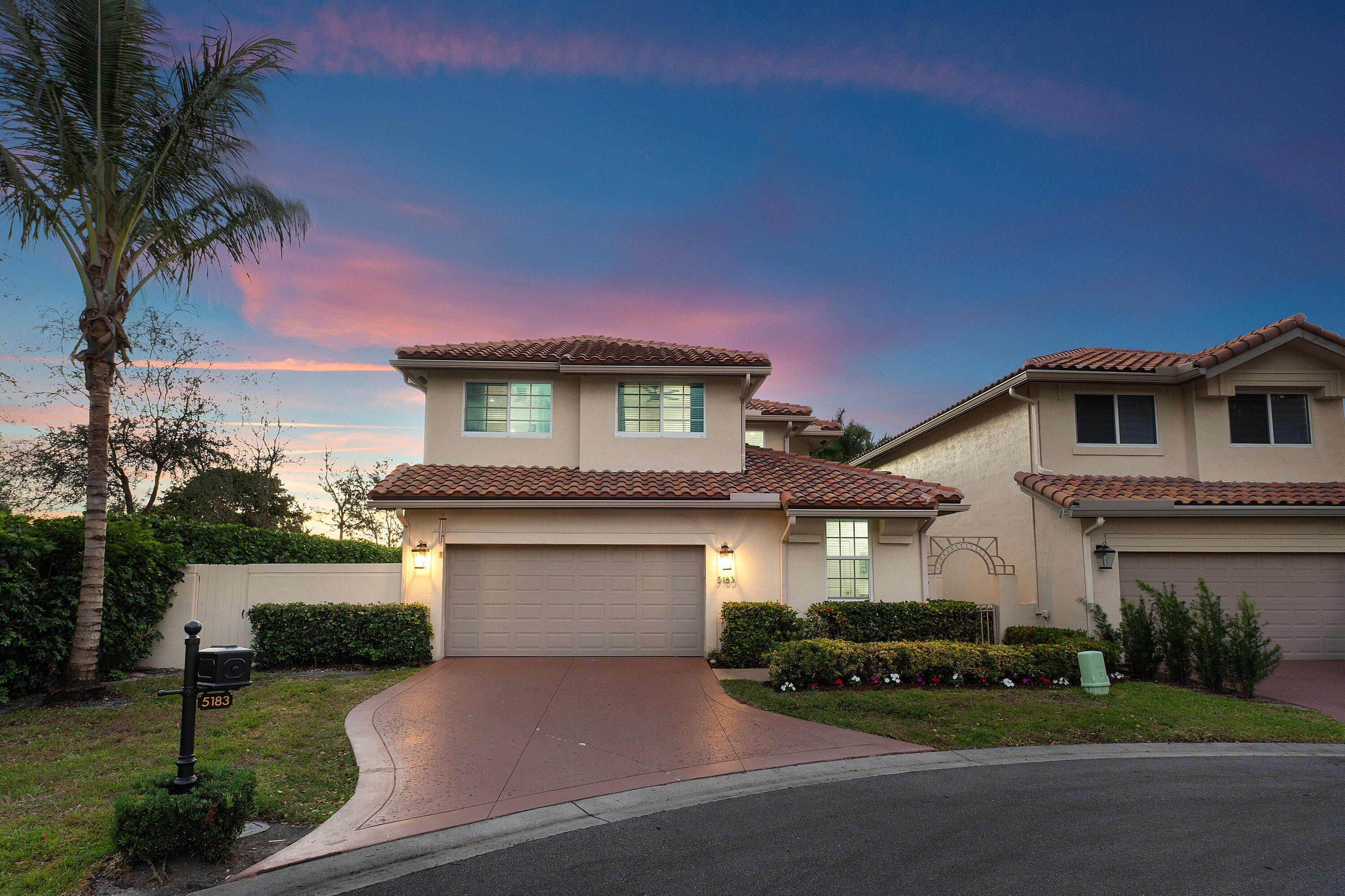5183 Northwest 25th Way Boca Raton, FL 33496 - Photo 52 of 73 a front view of a house with a garden and plants