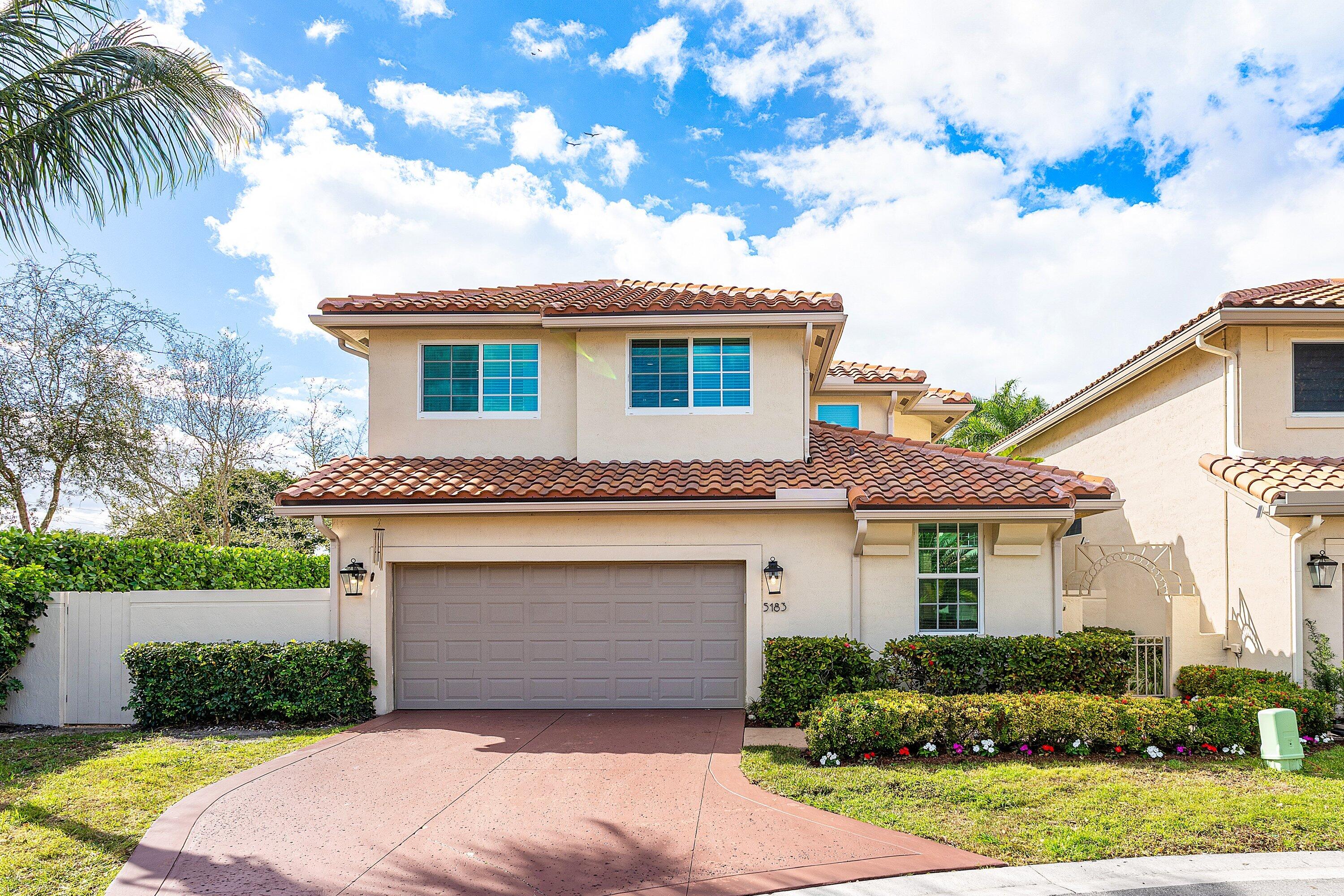 5183 Northwest 25th Way Boca Raton, FL 33496 - Photo 73 of 73 a front view of a house with a garden
