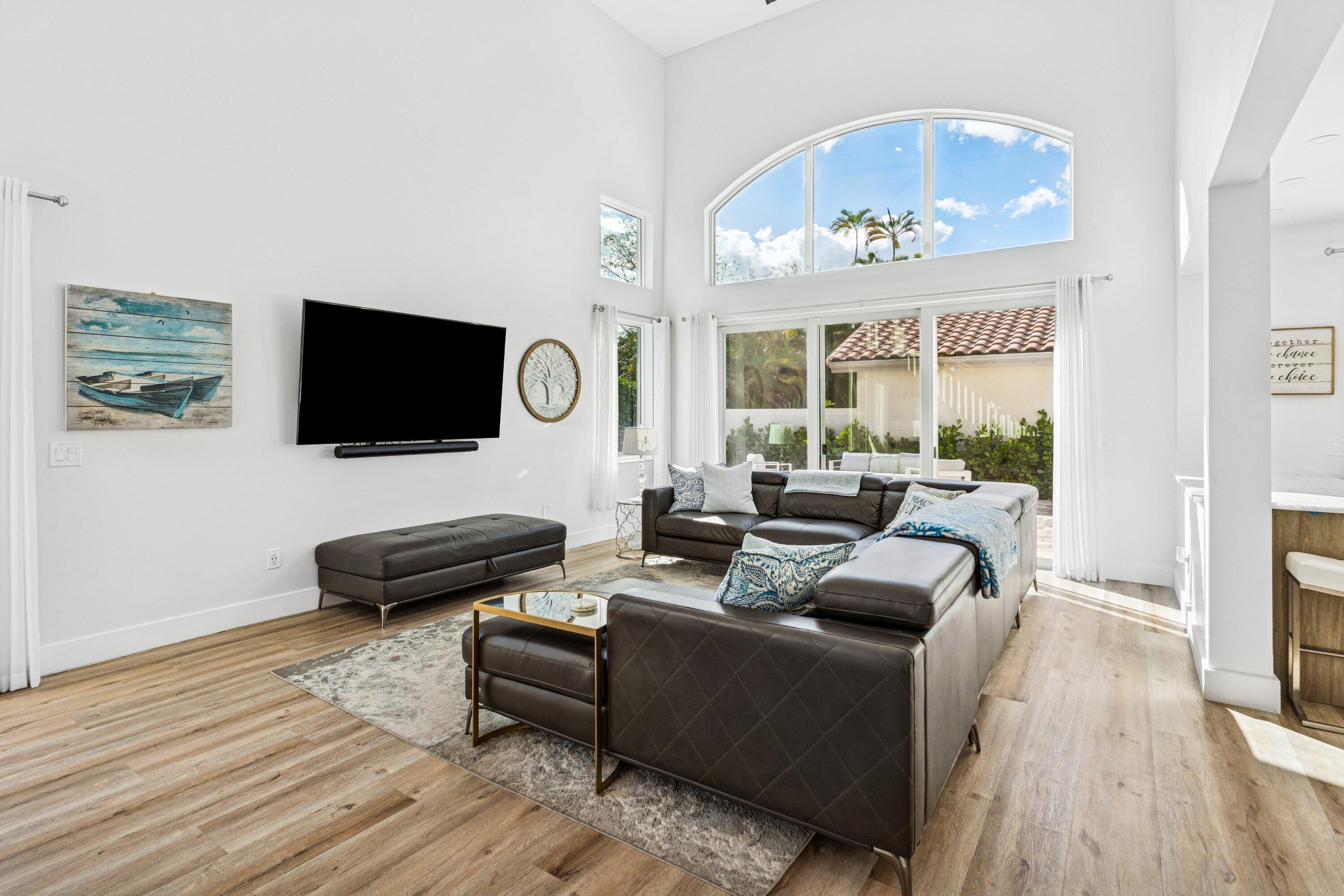 5183 Northwest 25th Way Boca Raton, FL 33496 - Photo 8 of 73 a living room with furniture flat screen tv and wooden floor