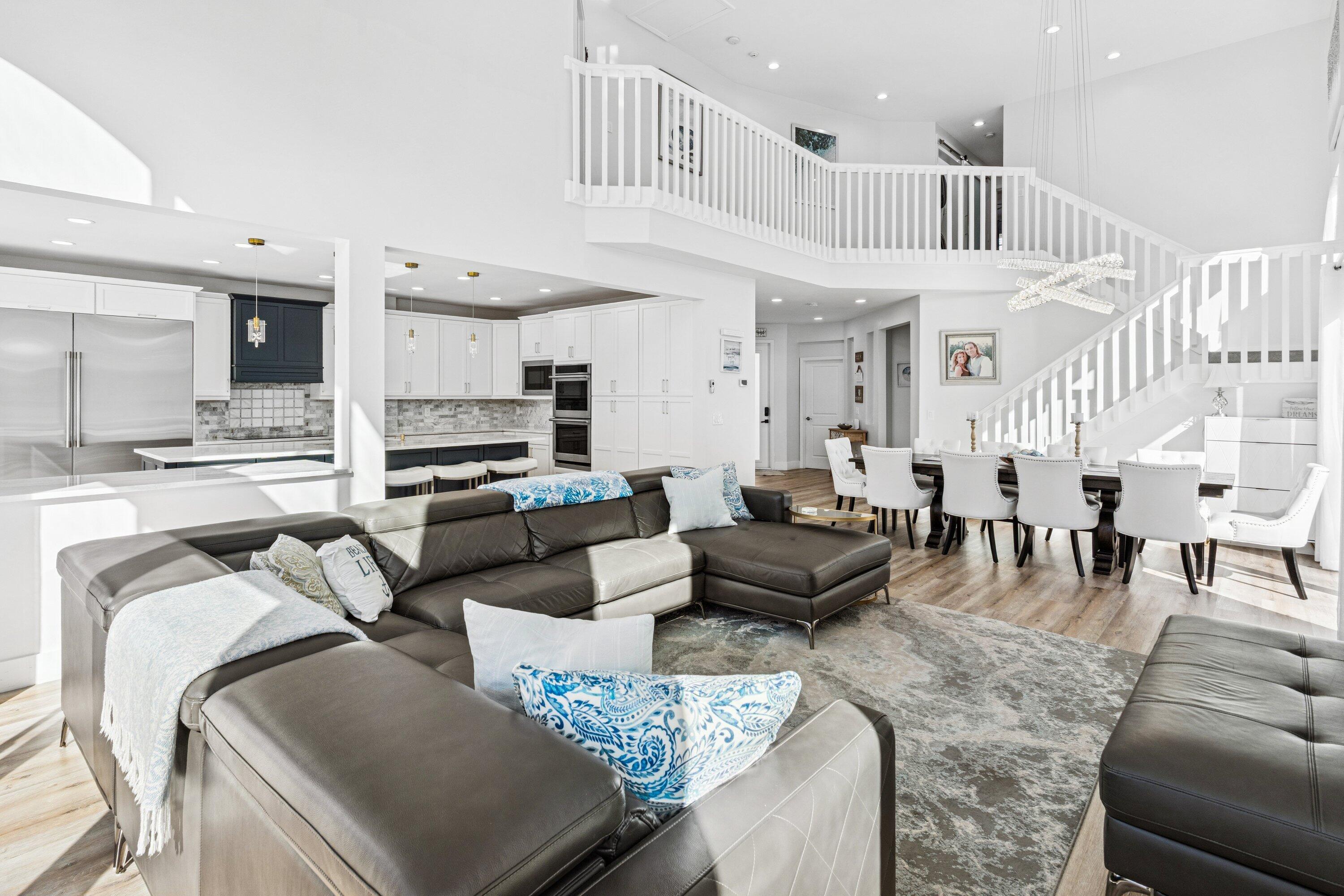 5183 Northwest 25th Way Boca Raton, FL 33496 - Photo 9 of 73 a living room with furniture wooden floor and kitchen view