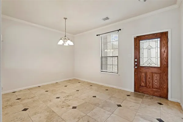 a view of an empty room with window and cabinet