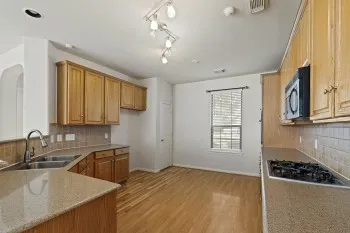 a kitchen that has a sink and a stove in it