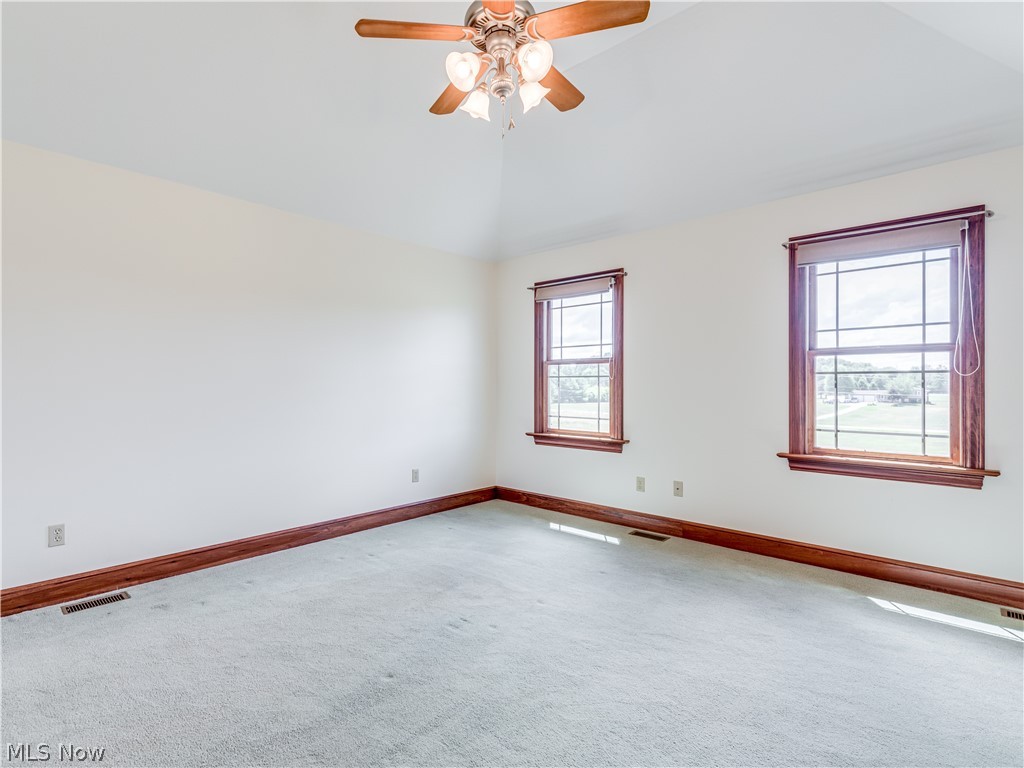 4840 Industry Road Ravenna, OH 44266 - Photo 22 of 32 Master bedroom with vaulted ceiling and fan. Windows overlook the front of the home. Home faces North.