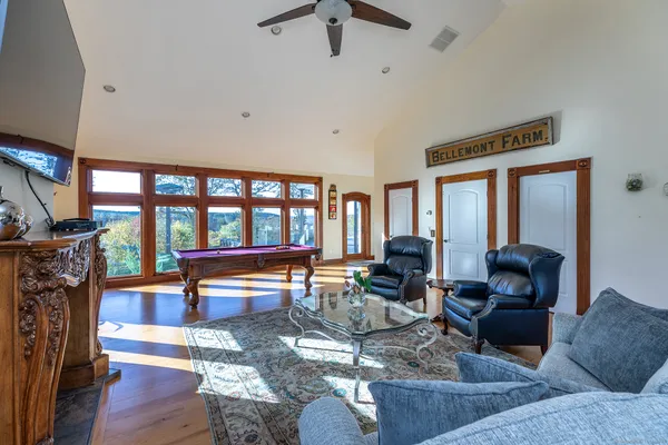 a living room with furniture a fireplace and a floor to ceiling window
