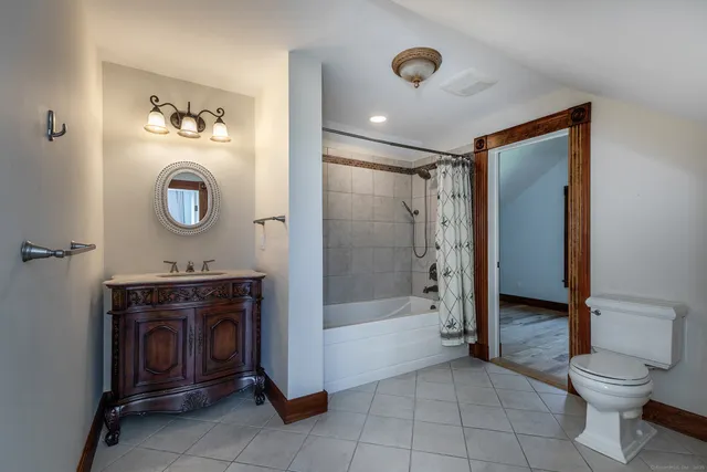 a bathroom with a toilet a sink and shower