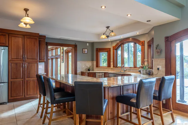 a dining room with furniture a chandelier and window