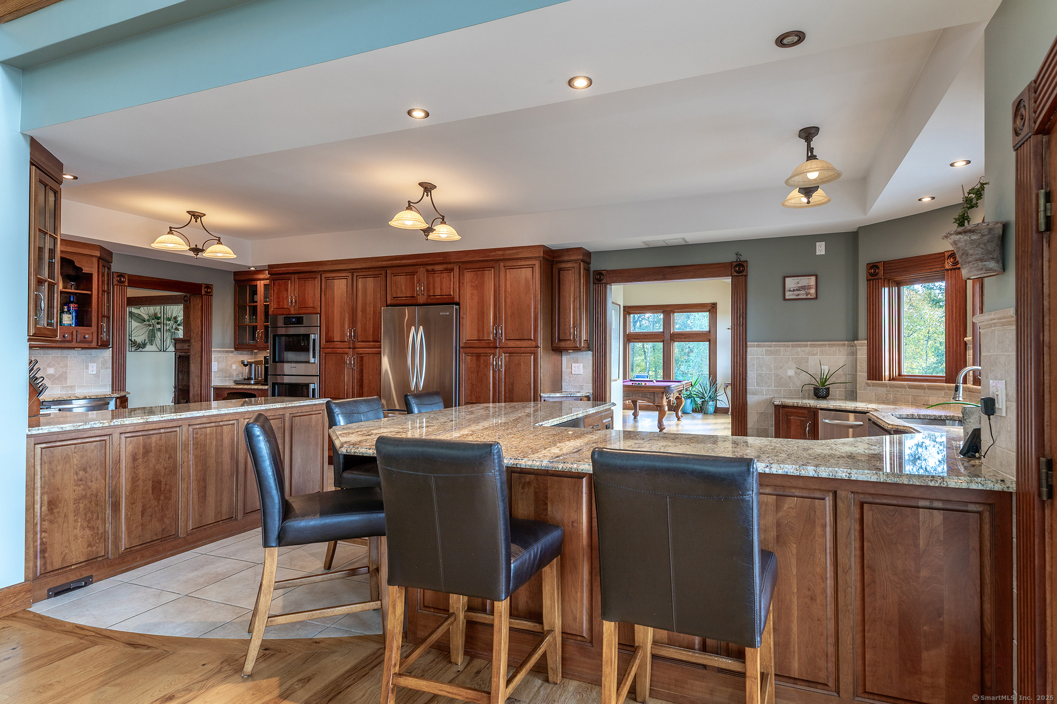 8 Bobcat Lane Warren, CT 06754 - Photo 9 of 40 a dining hall with stainless steel appliances kitchen island granite countertop a dining table and chairs