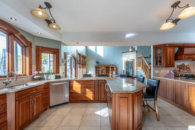 a kitchen with granite countertop sink cabinets and stainless steel appliances
