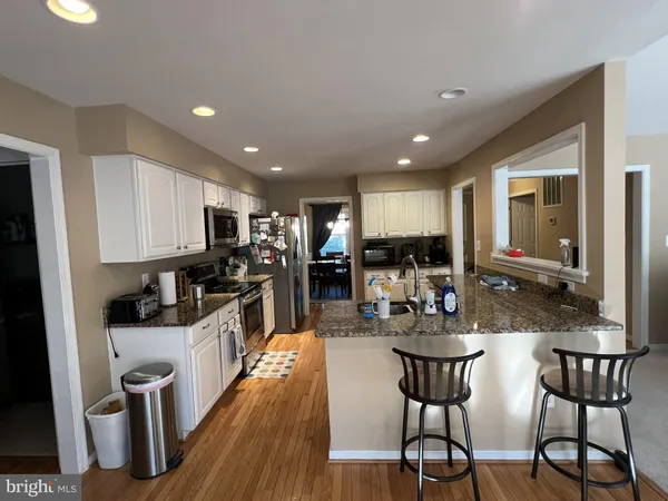 a kitchen with granite countertop a sink and cabinets
