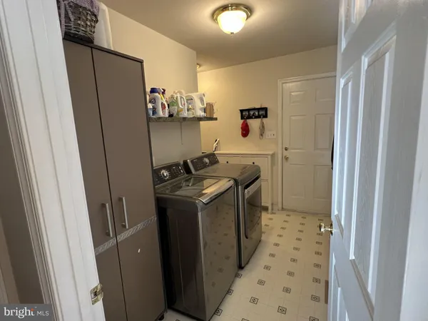 a bedroom with a bed a couch and dresser