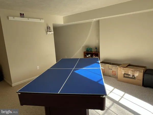 a room with furniture pool table and windows