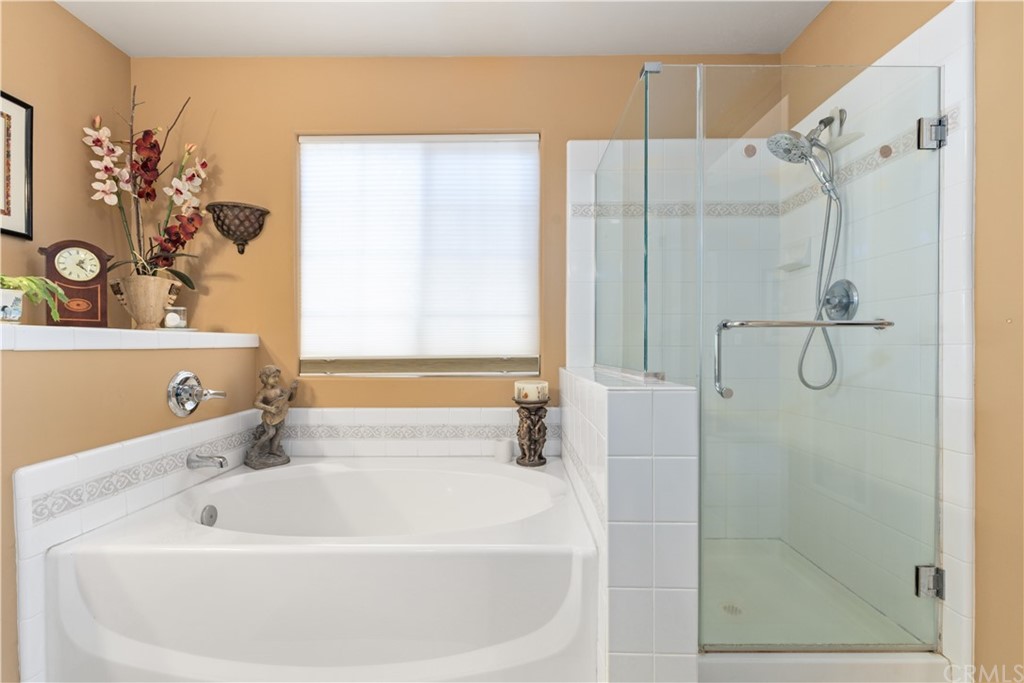 1612 Via Flora Paso Robles, CA 93446 - Photo 20 of 35 a bathroom with a white bath tub sitting next to a shower