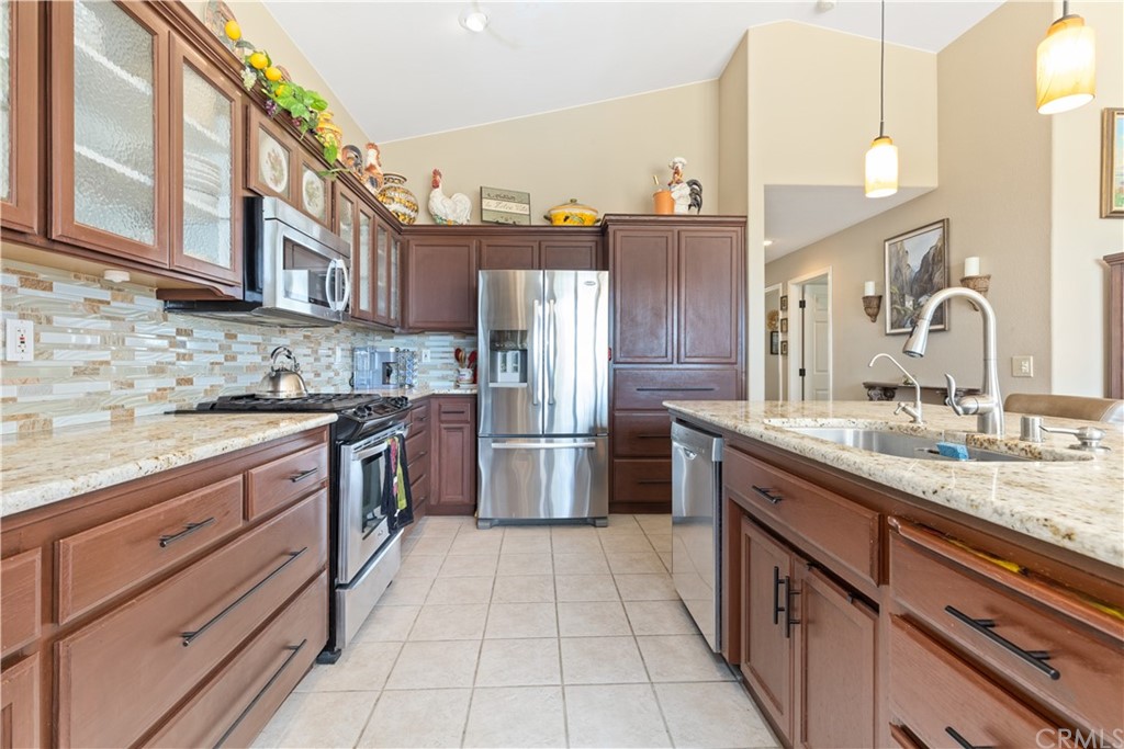 1612 Via Flora Paso Robles, CA 93446 - Photo 5 of 35 a kitchen with stainless steel appliances granite countertop a sink and a refrigerator