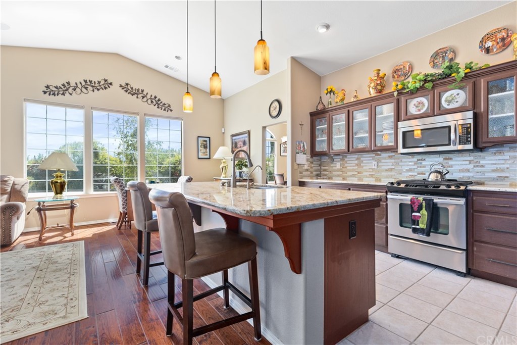 1612 Via Flora Paso Robles, CA 93446 - Photo 6 of 35 a open kitchen with stainless steel appliances granite countertop a stove and cabinets
