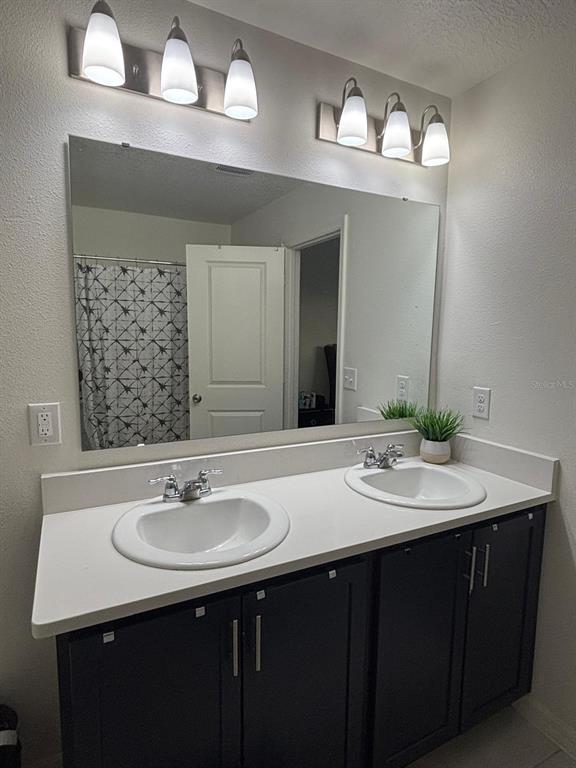3166 Sweet Acrs Place St. Cloud, FL 34772 - Photo 12 of 27 a bathroom with a sink and a mirror