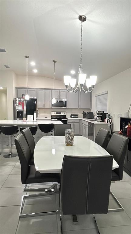 3166 Sweet Acrs Place St. Cloud, FL 34772 - Photo 6 of 27 a kitchen with a dining table chairs and white cabinets