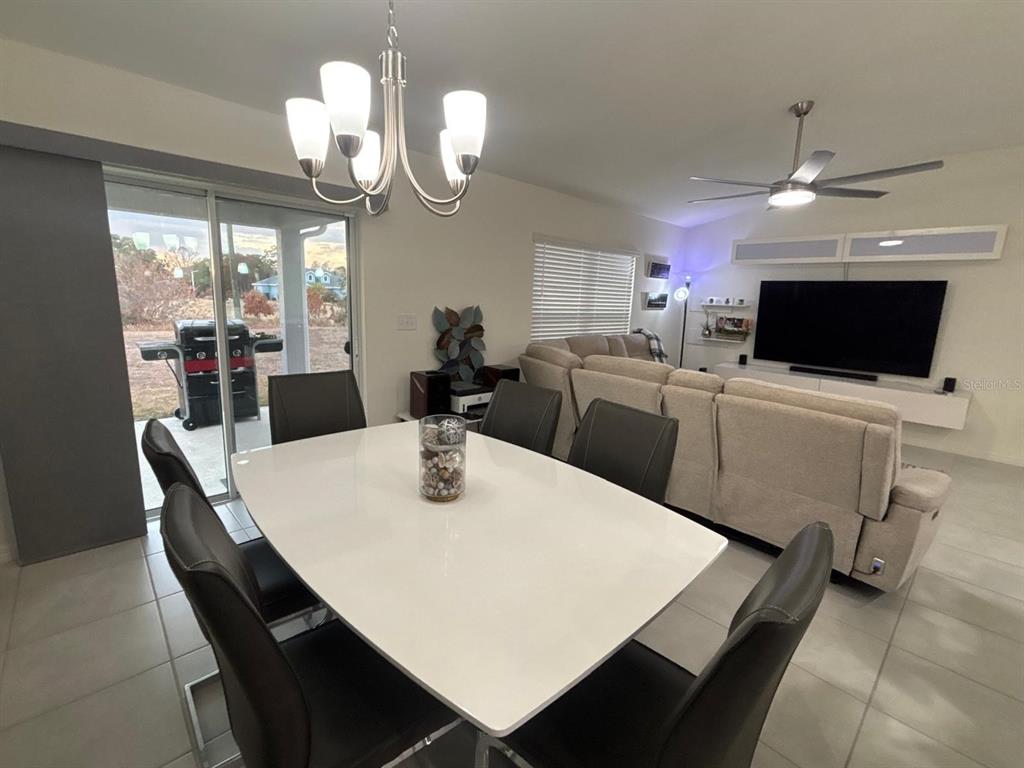3166 Sweet Acrs Place St. Cloud, FL 34772 - Photo 7 of 27 a view of a dining room with furniture and a chandelier