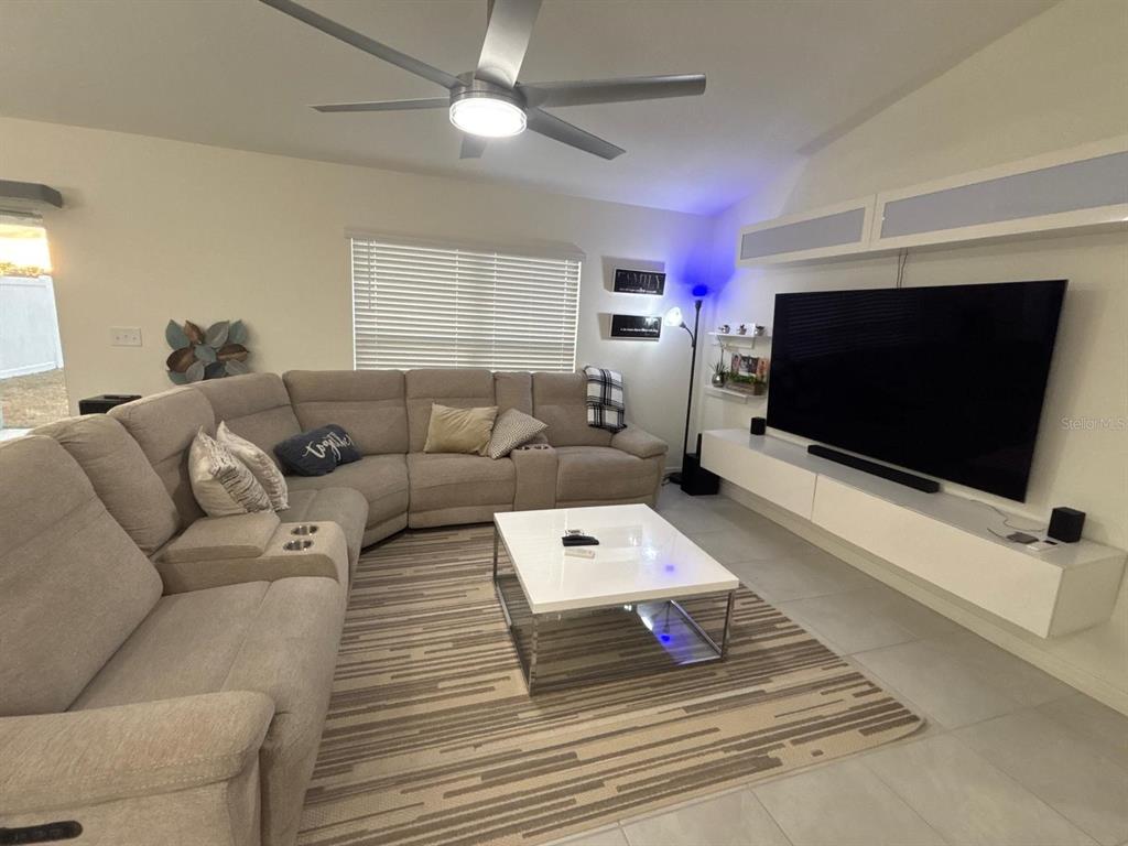 3166 Sweet Acrs Place St. Cloud, FL 34772 - Photo 8 of 27 a living room with furniture and a flat screen tv