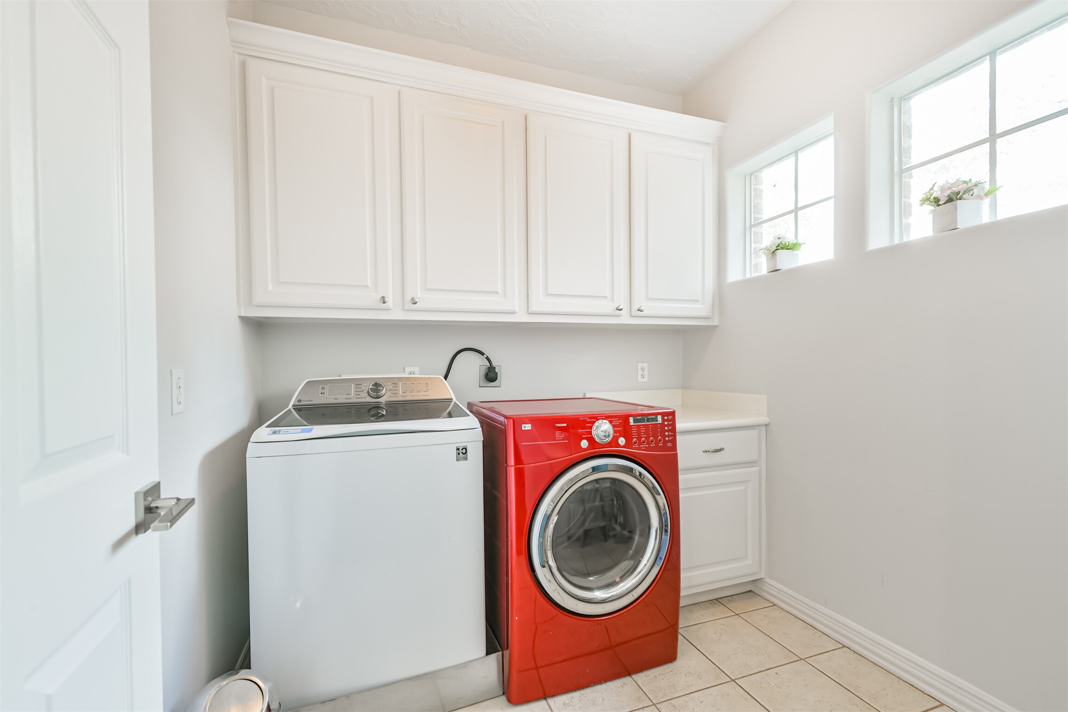 12636 Briar Patch Drive Houston, TX 77077 - Photo 33 of 43 The utility room is located on the third floor with tile floors and cabinets.