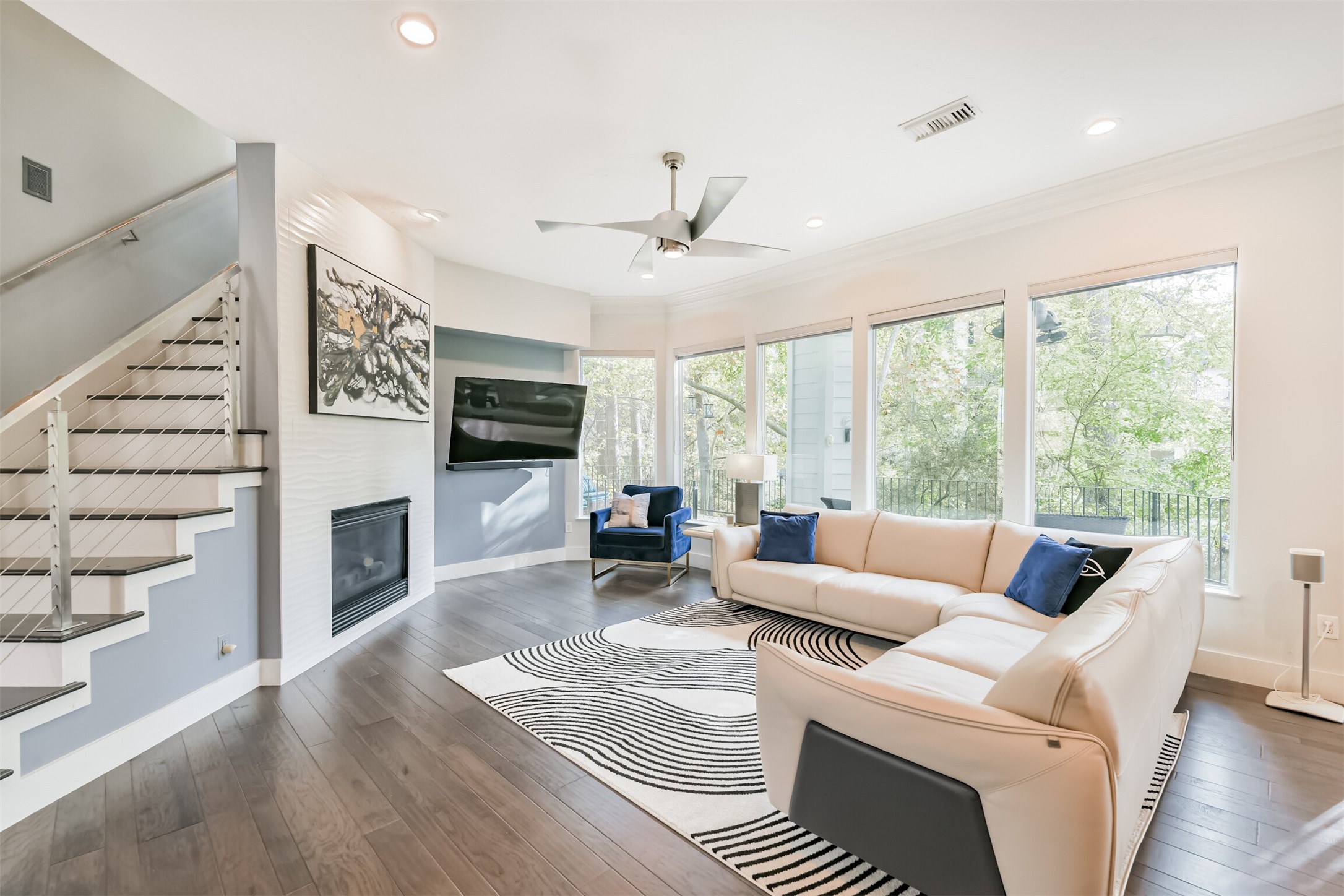 12636 Briar Patch Drive Houston, TX 77077 - Photo 6 of 43 The family room has LED recessed lighting, an updated ceiling fan, crown molding and wall of windows with views of the ravine/bayou located behind the house.